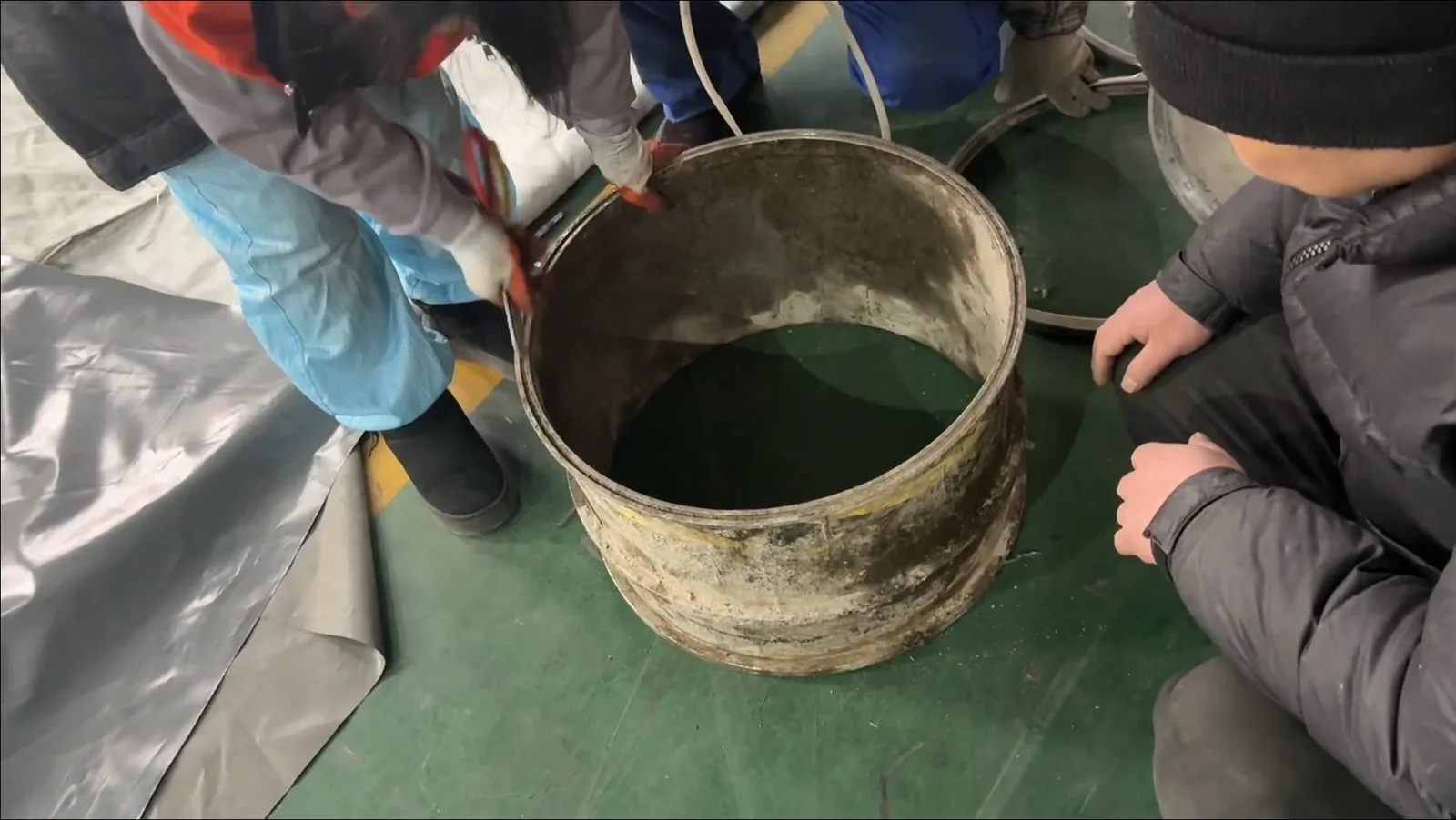 Worker mixing sewer repair resin in bucket on a San Tan Valley job site